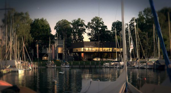 Ein Klubhaus auf Stelzen: Der Entwurf (oben) für das neue Heim des Yachtclub Bregenz am Hafen Suppersbach (links) ging aus einem geladenen Architekturwettbewerb hervor. Stiplovsek, Metzler. Schelling