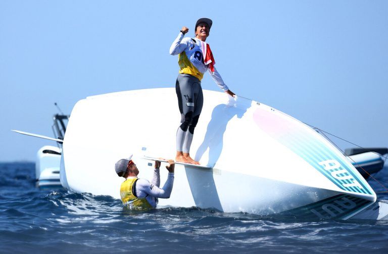 Als Lukas Mähr und Lara Vadlau Gewissheit über ihren Olympiasieg haben, kentern sie das Boot. Und jubeln auf dem Kopf über im Wasser stehenden Goldboot.Reuters (3), APA, (2), ÖOC